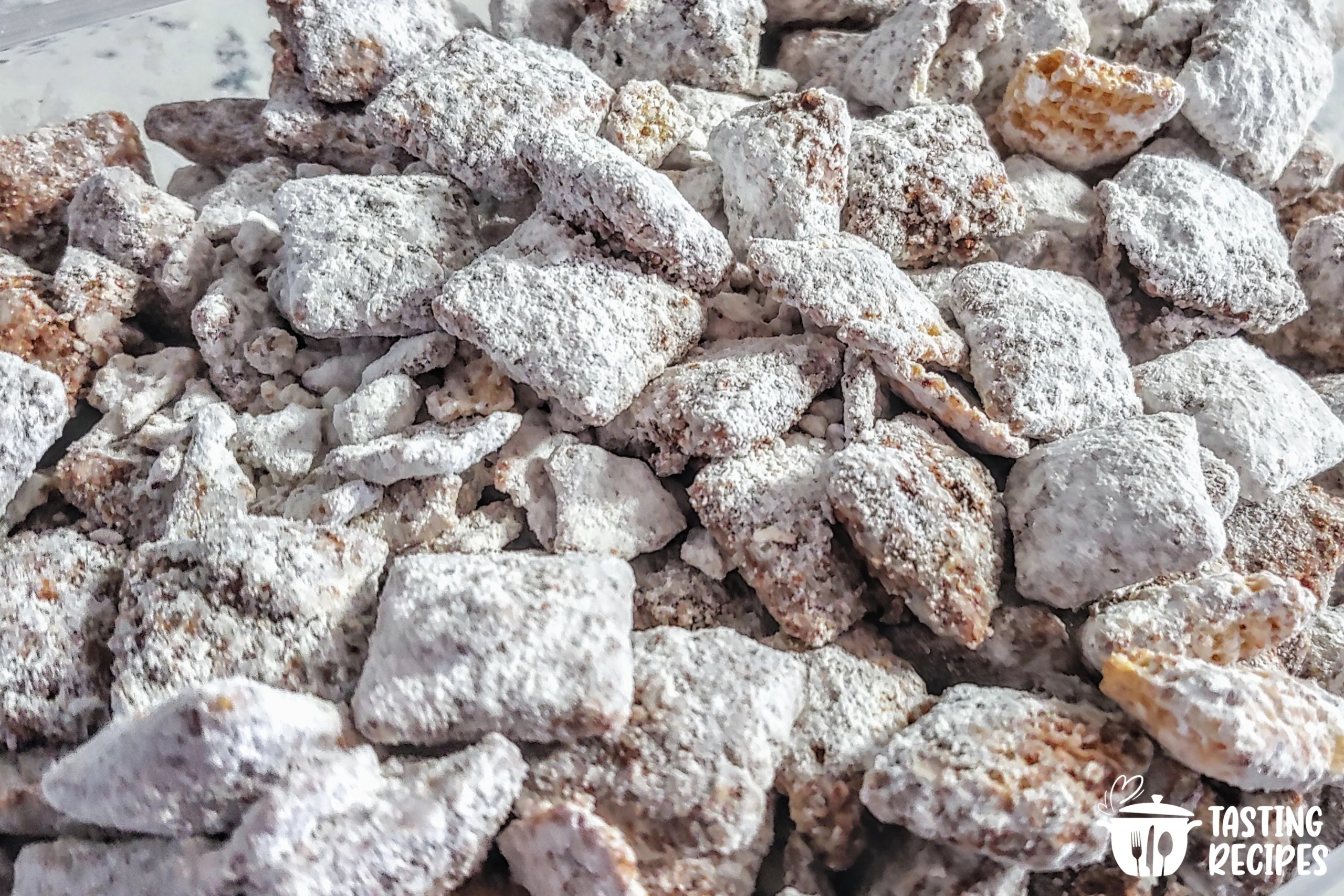 A bowl of pistachio puppy chow covered in powdered sugar