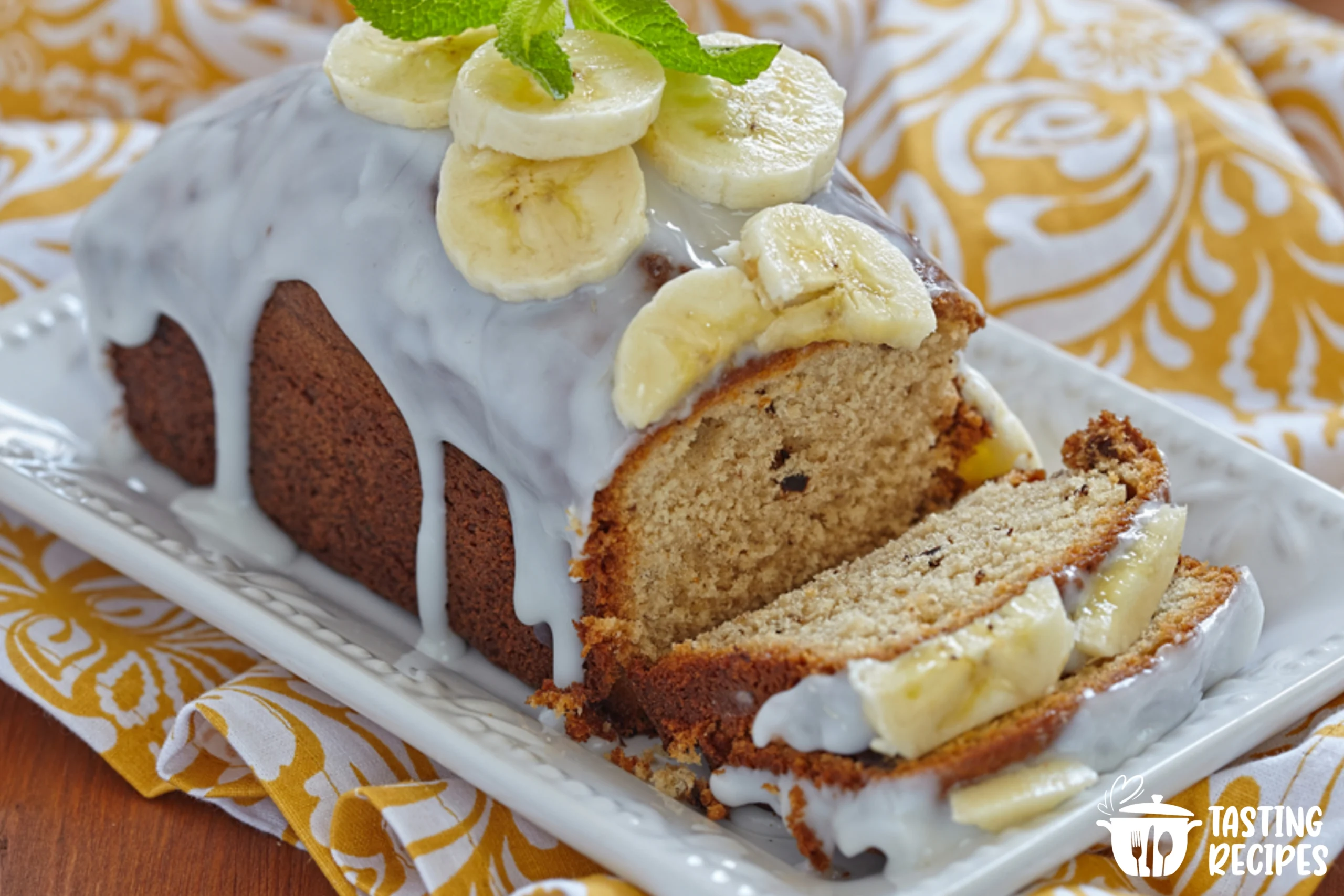 Banana bread with a shiny sugar glaze on a wooden board