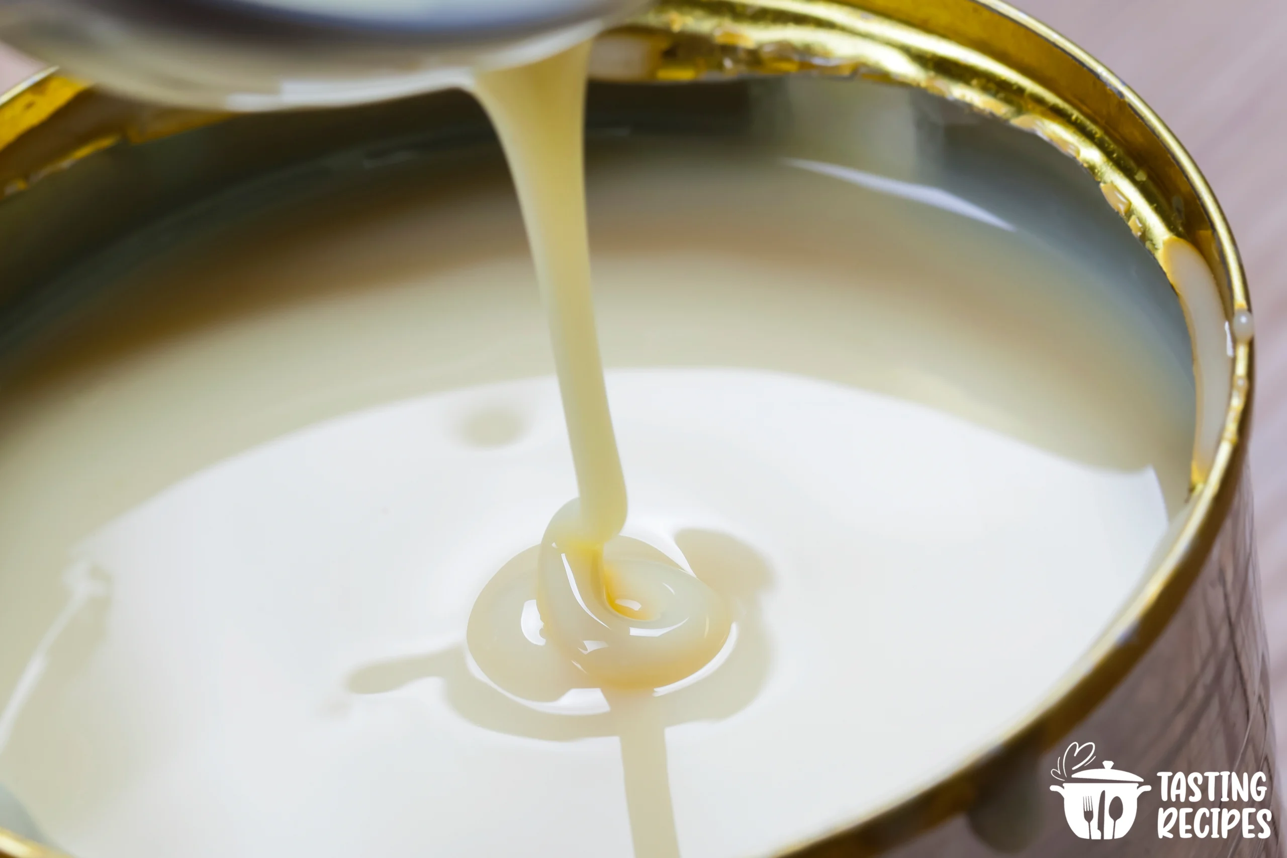 A jar of creamy keto condensed milk on a wooden table