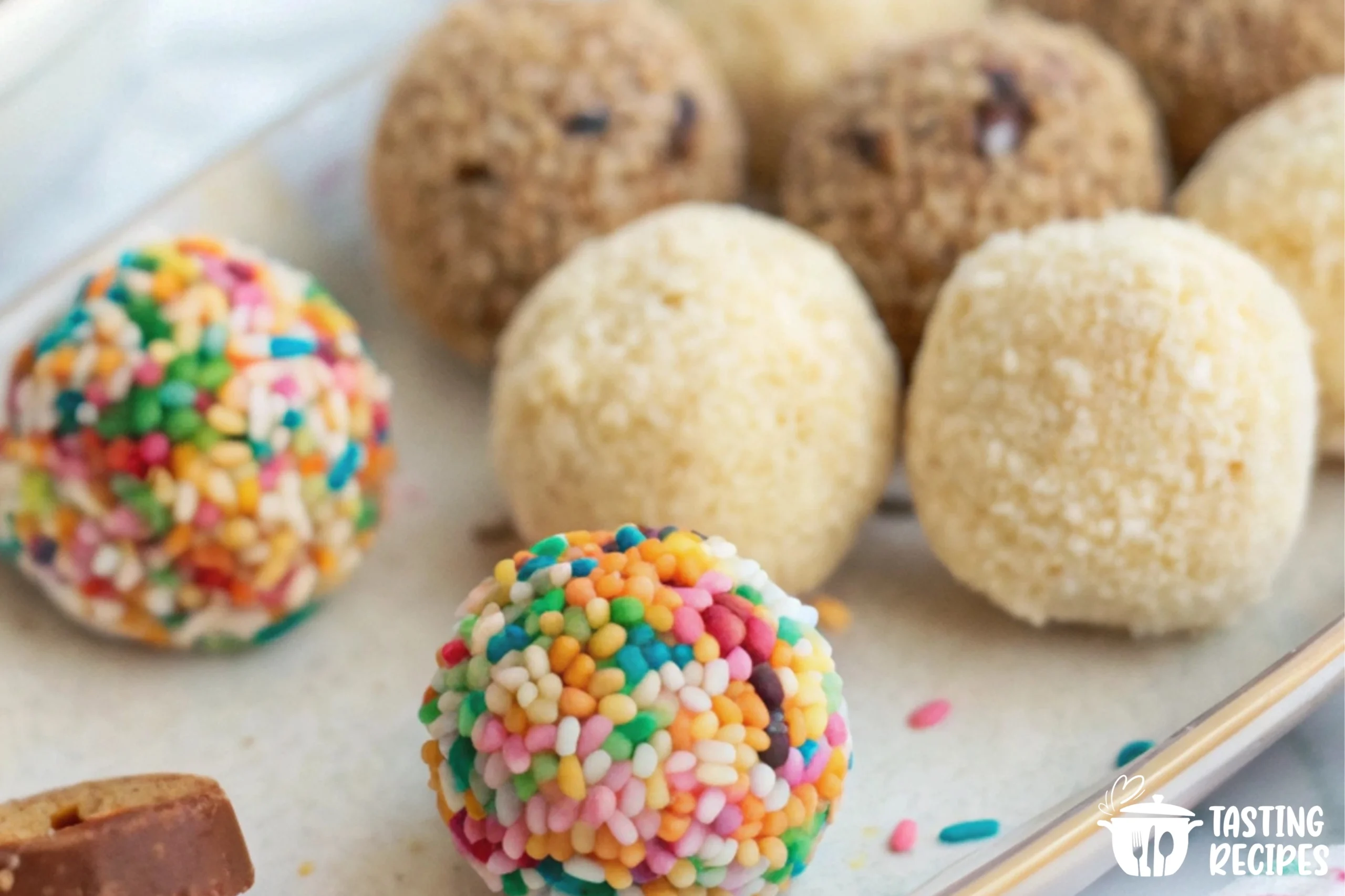 Plate of creamy cheesecake balls covered in chocolate and sprinkles