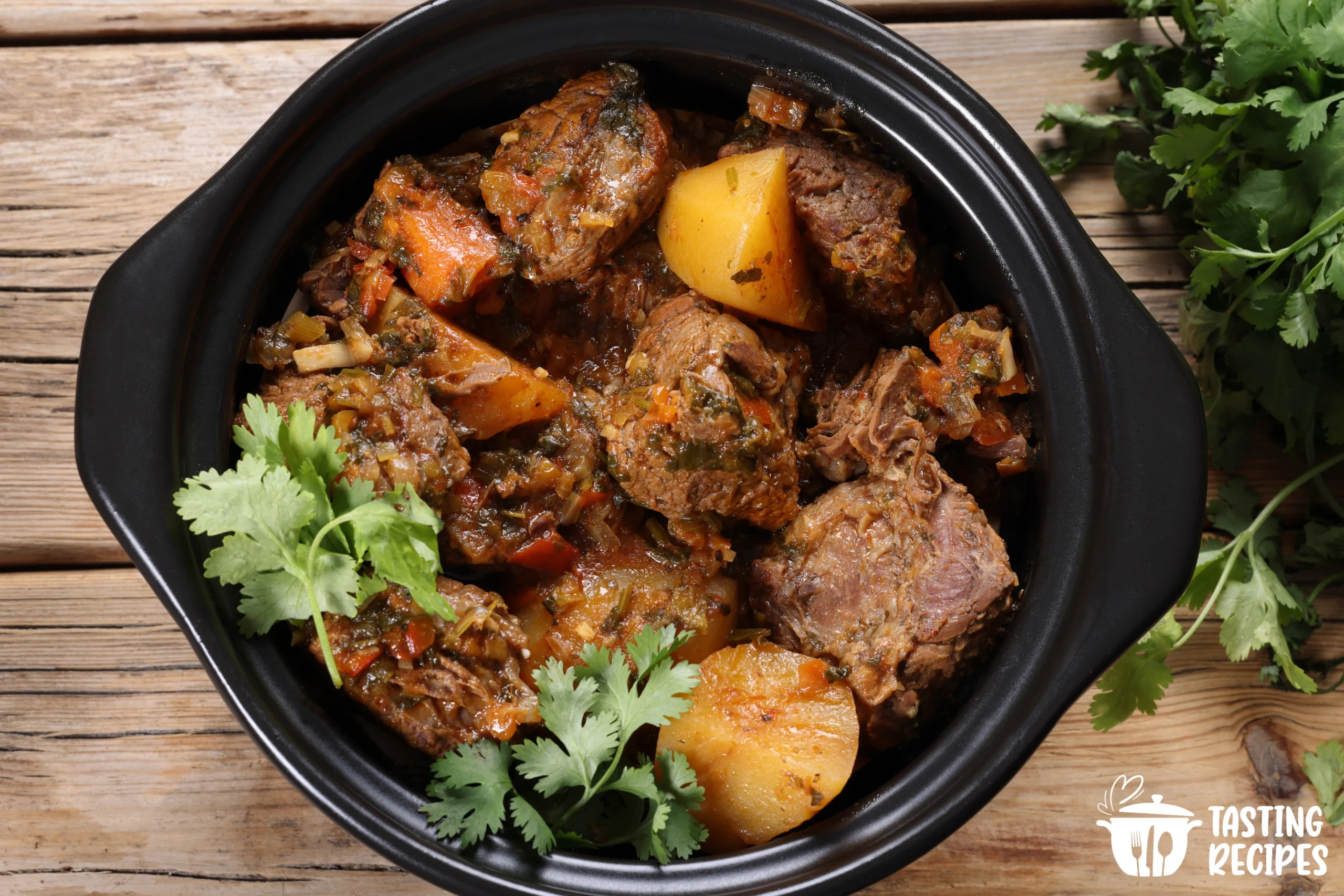 Beef casserole seasoned with herbs and spices in a white dish