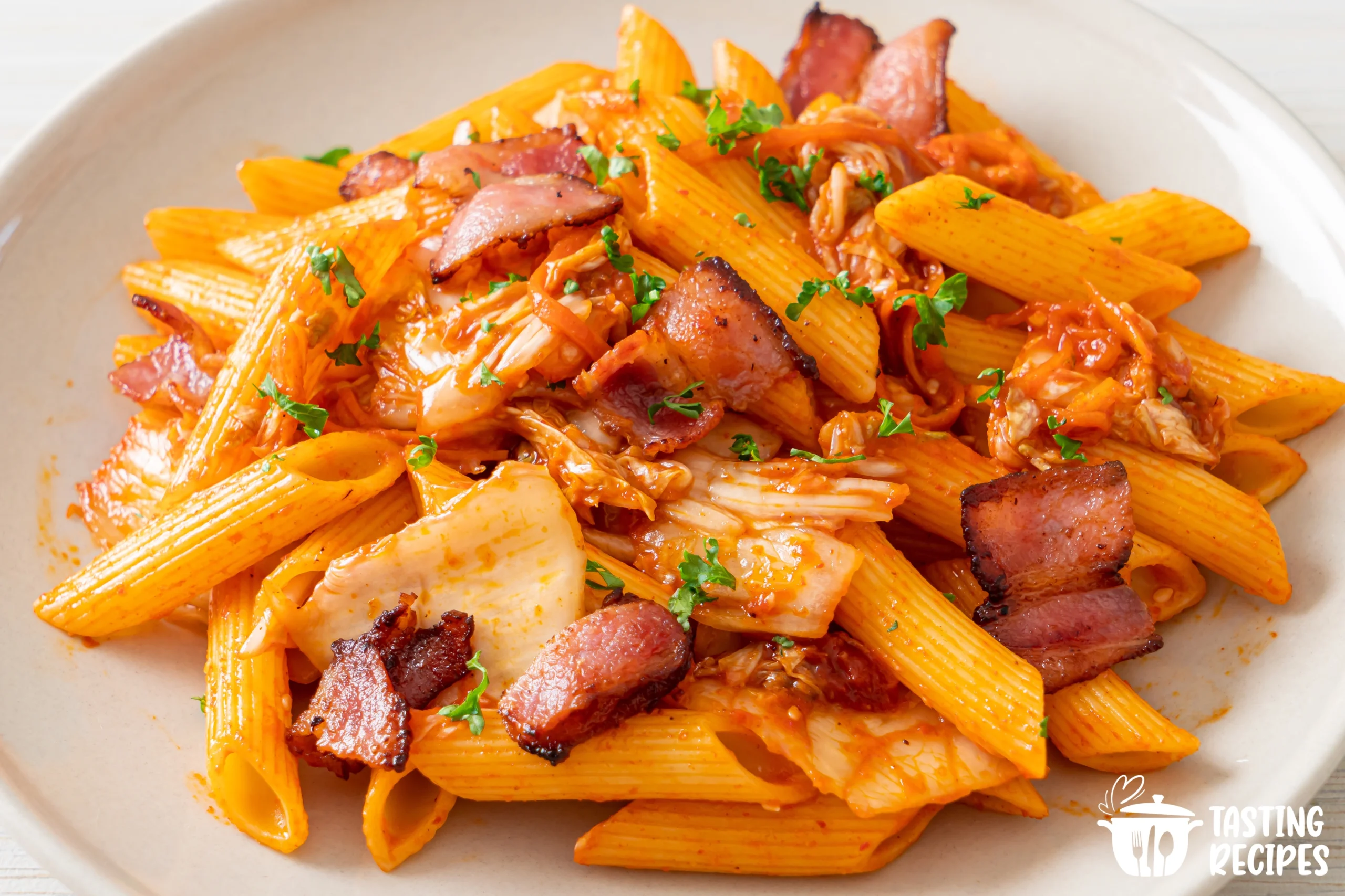 Crack Chicken Penne served in a bowl with melted cheese and green onions on top